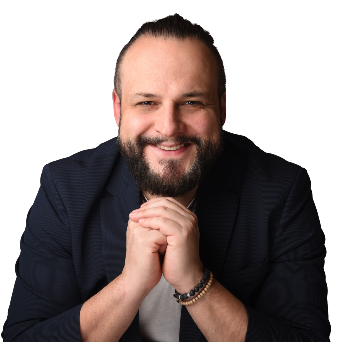 A portrait of Dennis Ego in business attire.